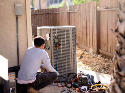 Technician working on an AC unit